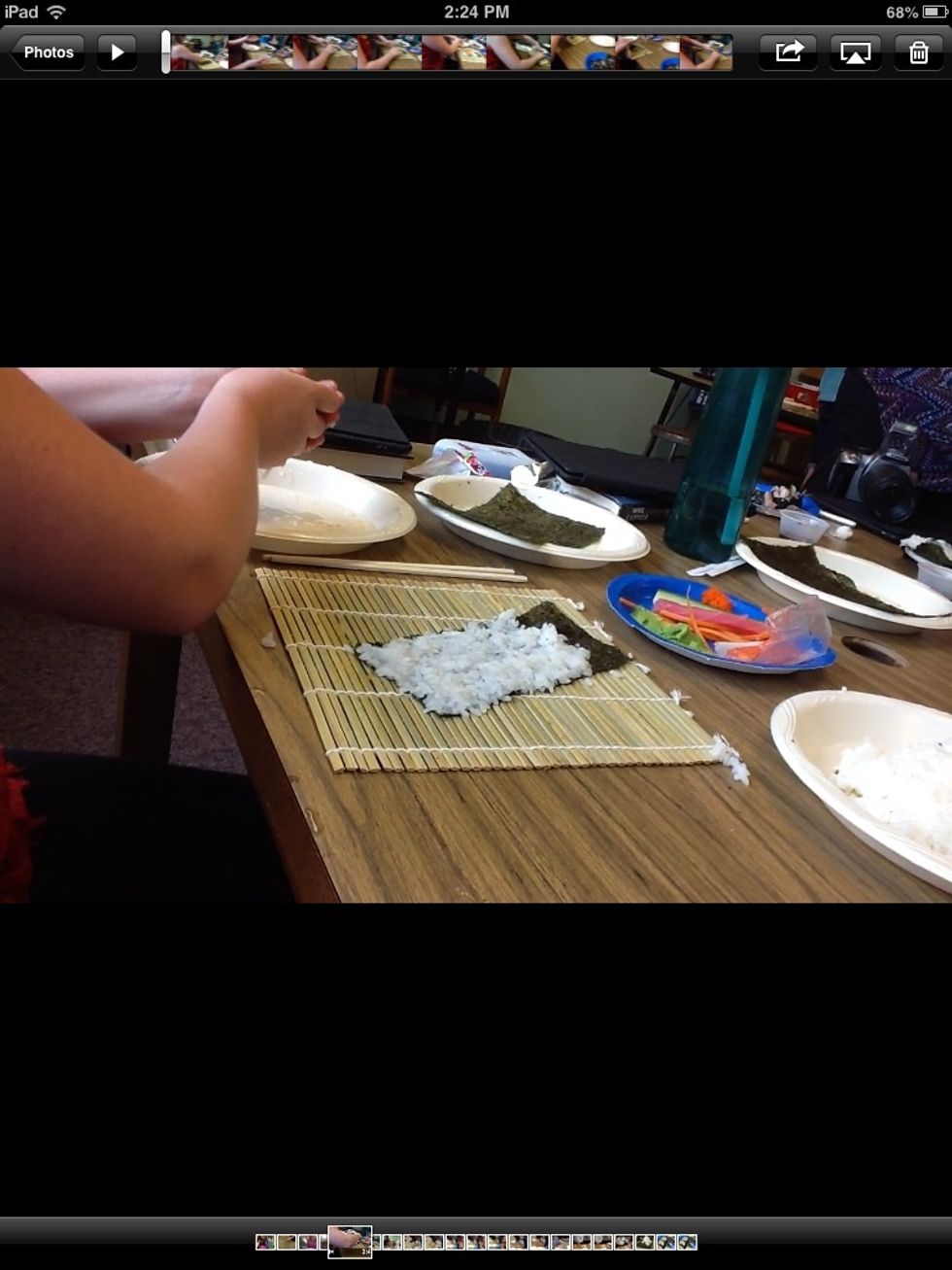 To spread the rice on the nori you need to carefully press it against the nori but the rice is sticky you need to wet your hands. Make sure your layer of rice is thin and you leave an inch un covered.