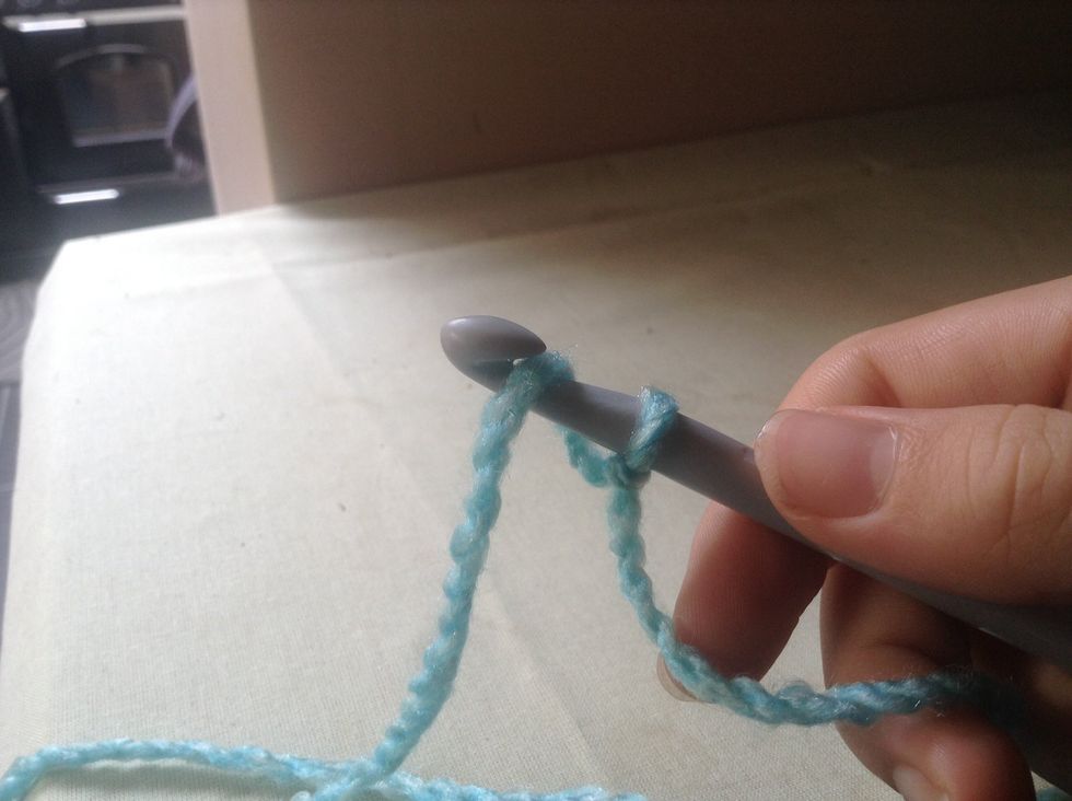 To start doing chains: put wool from right hand over the hook from far away from you to this side of the hook