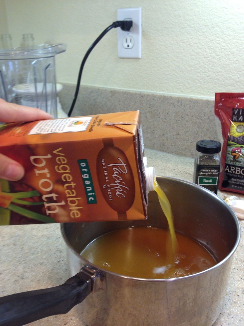 To start off, add your broth to a saucepan and throw it on the stove to heat. My veggie broth only comes with 4 cups in it, so I add 1/2 to 3/4 cups water to the pot as well.