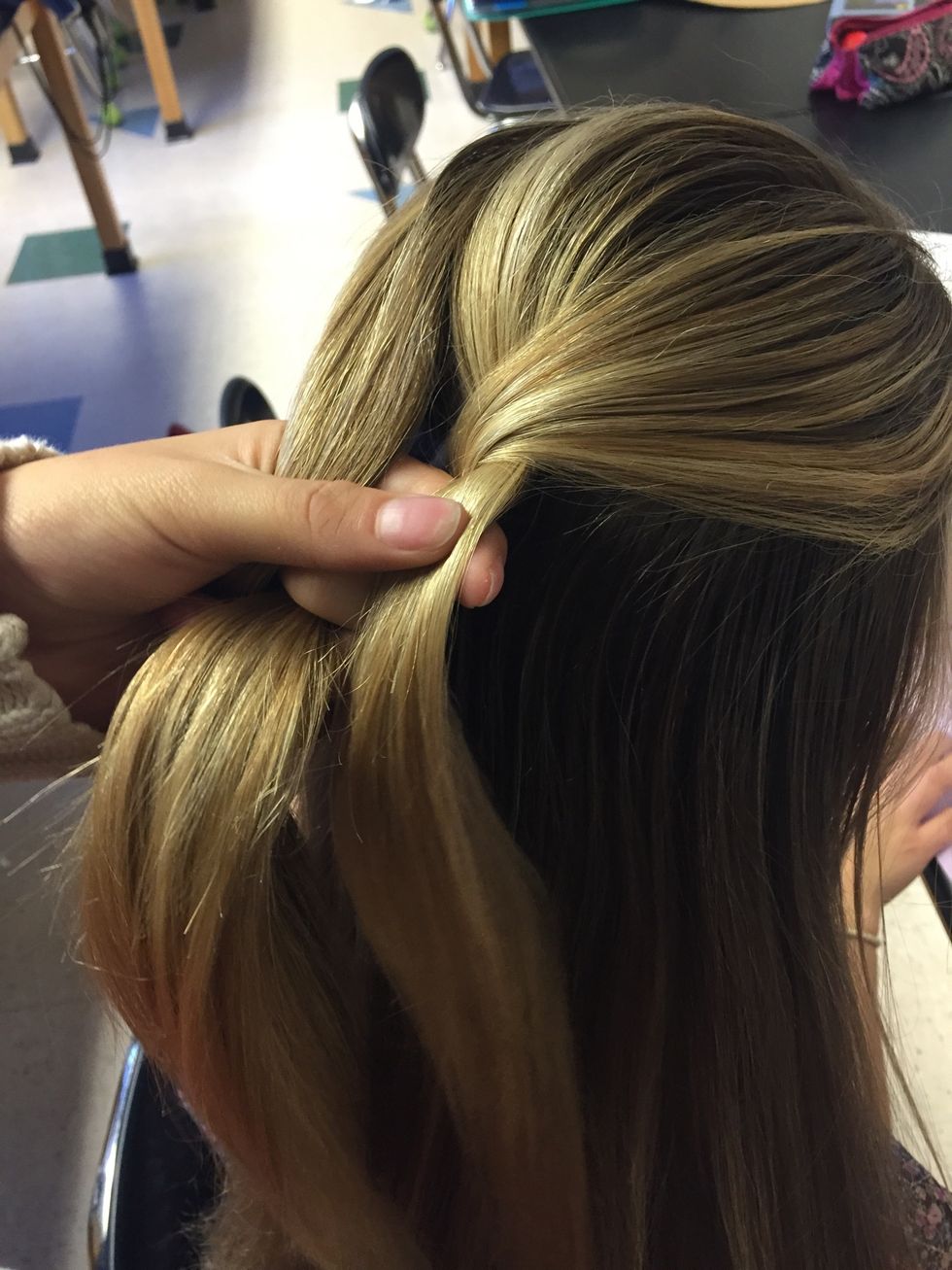 To start off cross the left piece of hair over the middle section and then the right piece of hair over the middle section like a normal braid