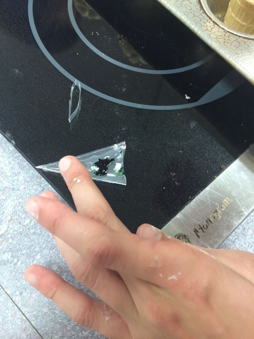 To start off the ice cream cone garnishing, put green food coloring on a piece of plastic or in a bowl and dip a toothpick in the green and swirl it on top of the buttercream.