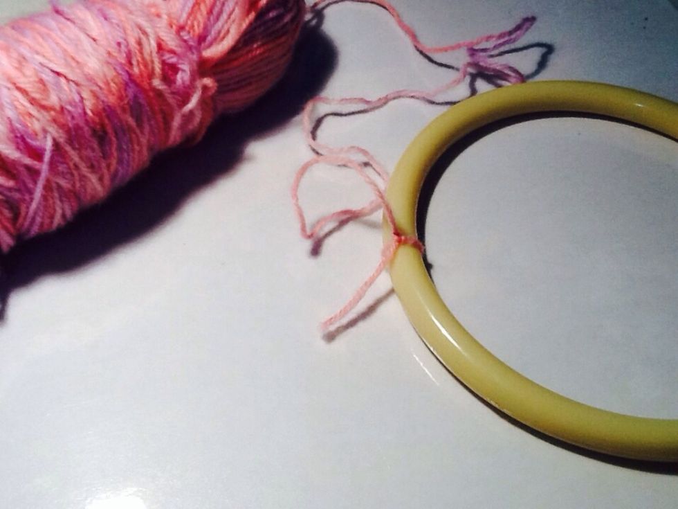 To start off, tie your yarn to your hoop securely.