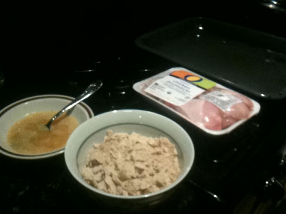 To start you'll need eggs, breadcrumbs, drumsticks, and a baking pan