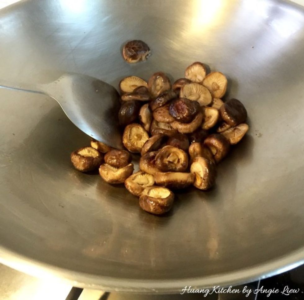 To stir fry the mushrooms, first heat up 1 tablespoon sesame oil in a wok. Add in soaked mushrooms. Stir fry over medium heat till fragrant & are fully infused with the sesame oil, about 5 minutes.