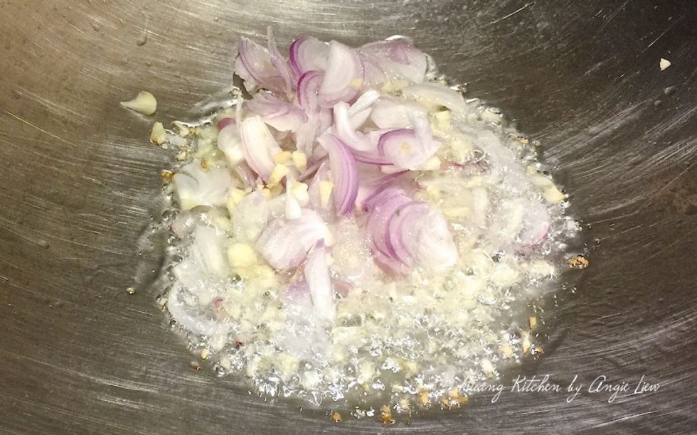 To stir fry the yam abacus, first heat up some oil in a wok. Then saute minced garlic and shallots till fragrant.