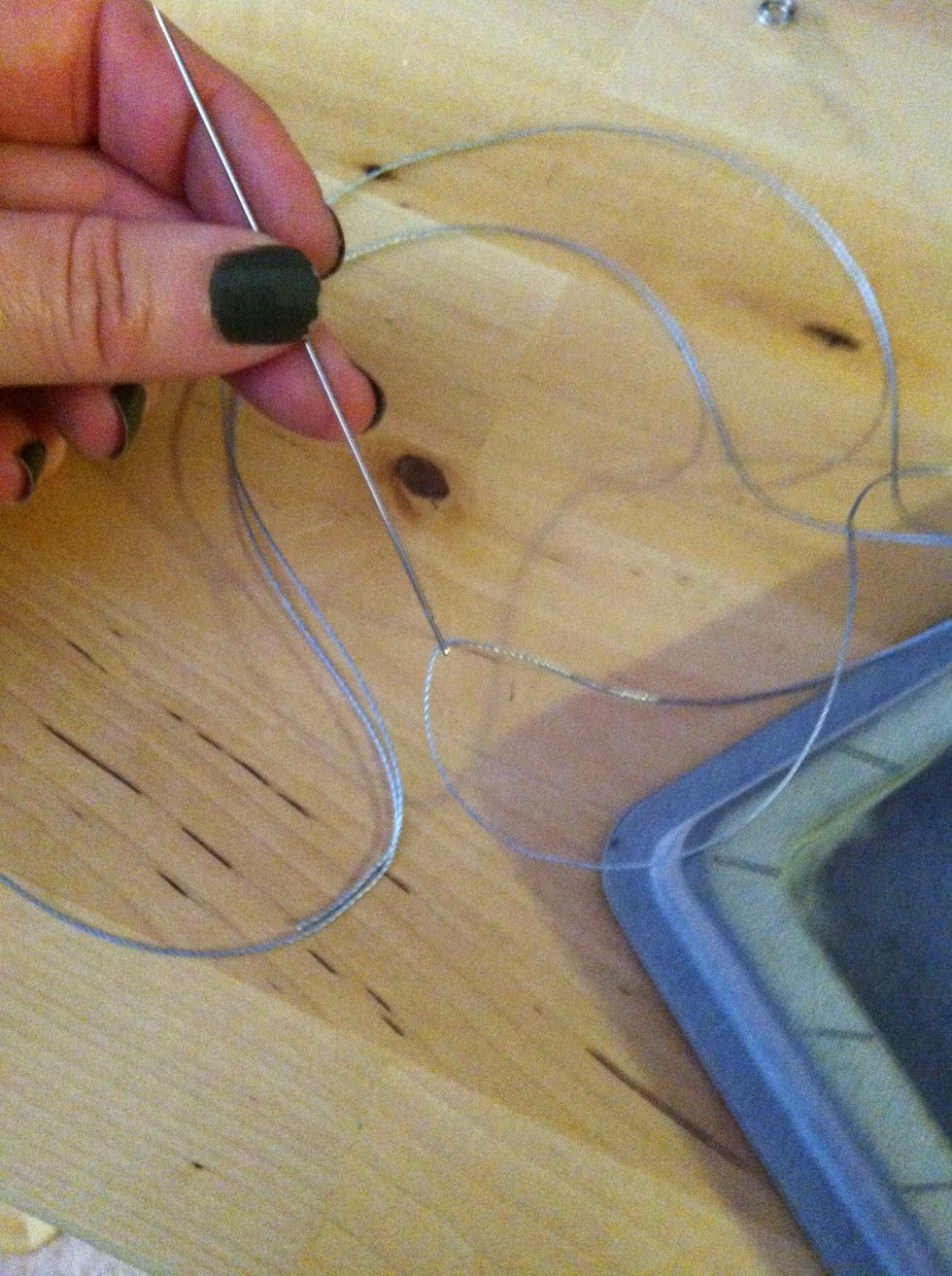 To string the beads into a bracelet, cut about 24" of heavy-duty thread and thread it through a long needle.