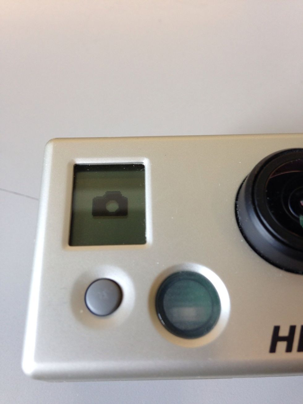 To take a photo, first press the Mode button until you reach the Photo mode.