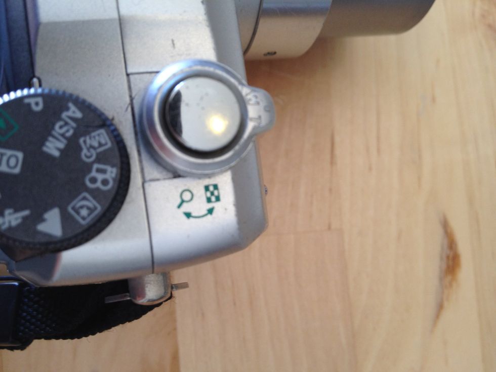 To take a photo, move the zoom control to "frame" the shot. Half press the button and the camera will focus - it will show a green light when ready. To take the photo press it all the way down