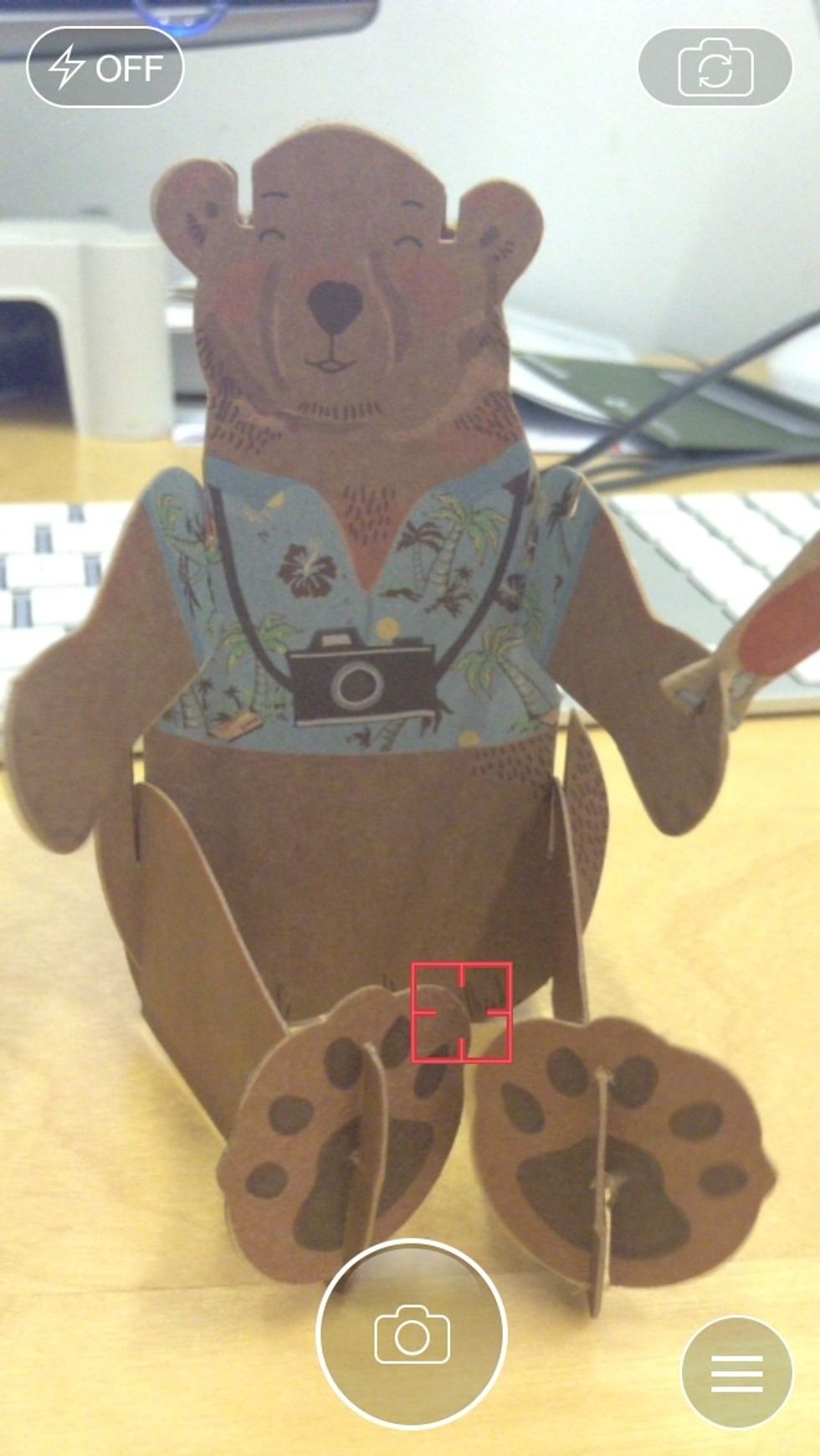 To take a Snap, hold the camera up and tap the shutter button in the bottom-centre of the screen.