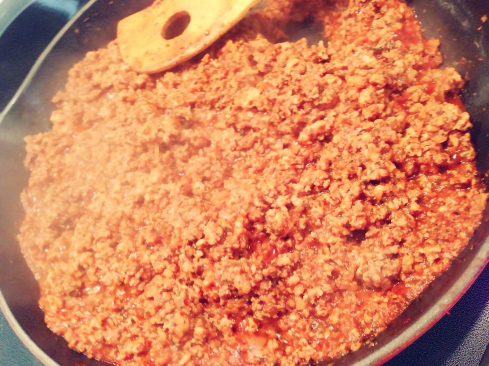 To the beef, add garlic salt, sweet basil, tomato paste, tomato sauce, and water. Simmer for 15 minutes.