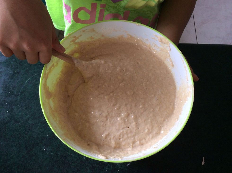 To the dry ingredients, add the combine wet ingredients, along with the banana. Stir the mixture with the wooden spoon until almost smooth.
