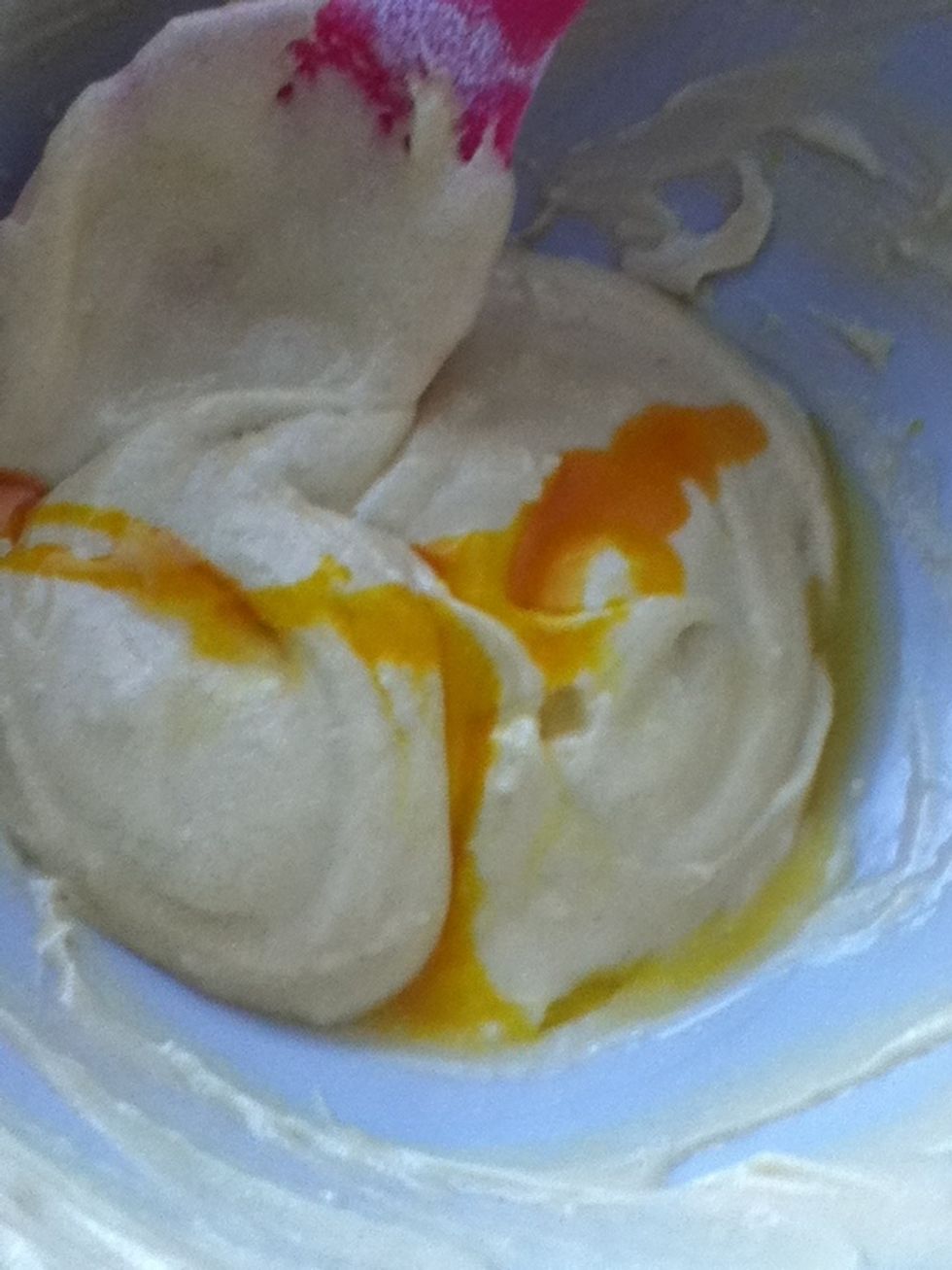 To the first bowl, add a teaspoon of vanilla essence and if you want to, a few drops of yellow food colouring. Then stir it in.