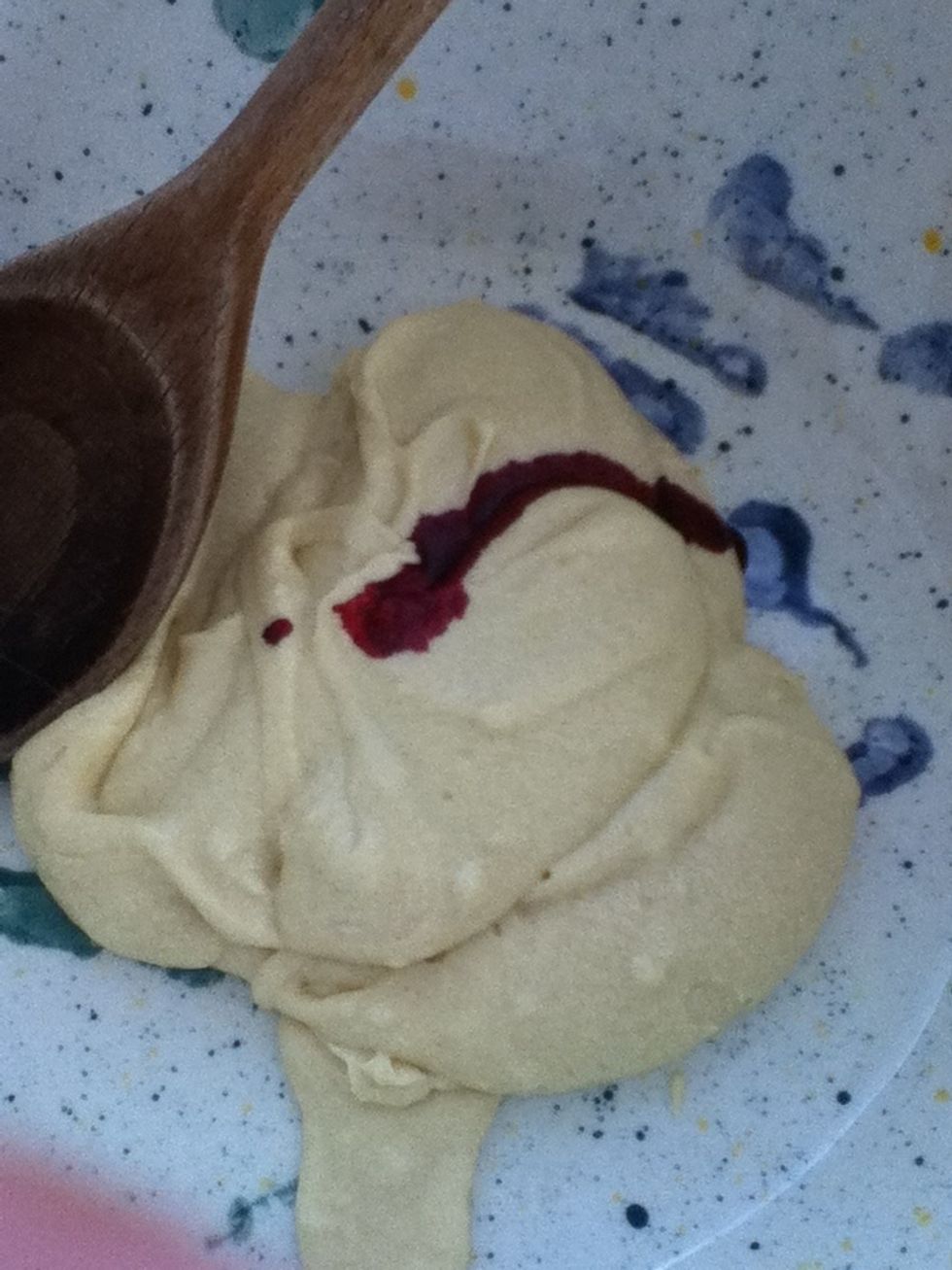 To the second bowl add a few drops of red food colouring and a teaspoon of almond extract.