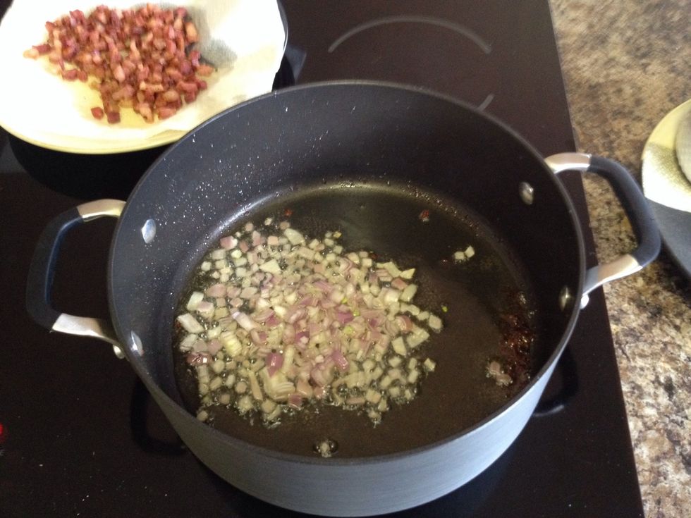 To the yummy pancetta juices, add the diced shallot. Stir frequently for about 2-3 mins. Then add chicken broth, make sure to scrape up the brown bits on the bottom of the pan.