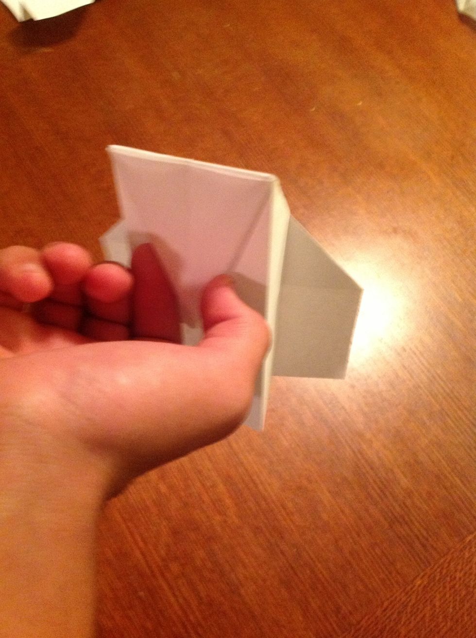 To throw the plane hold it by the bottom triangle.