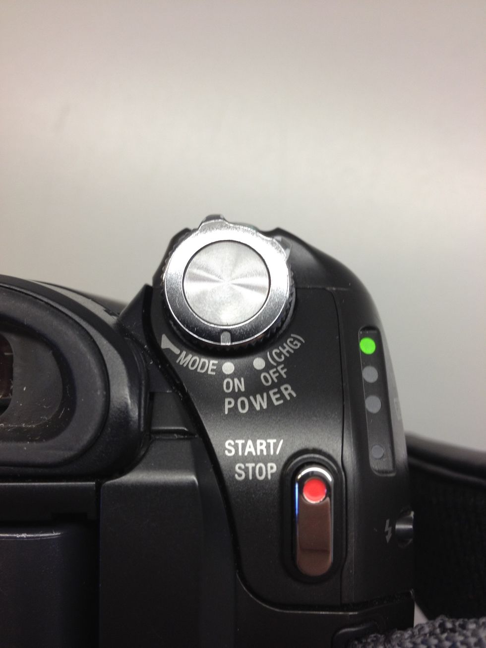 To turn the device on, hold down the green button (on the top) and rotate the grey dial. To change modes, rotate the dial again.
