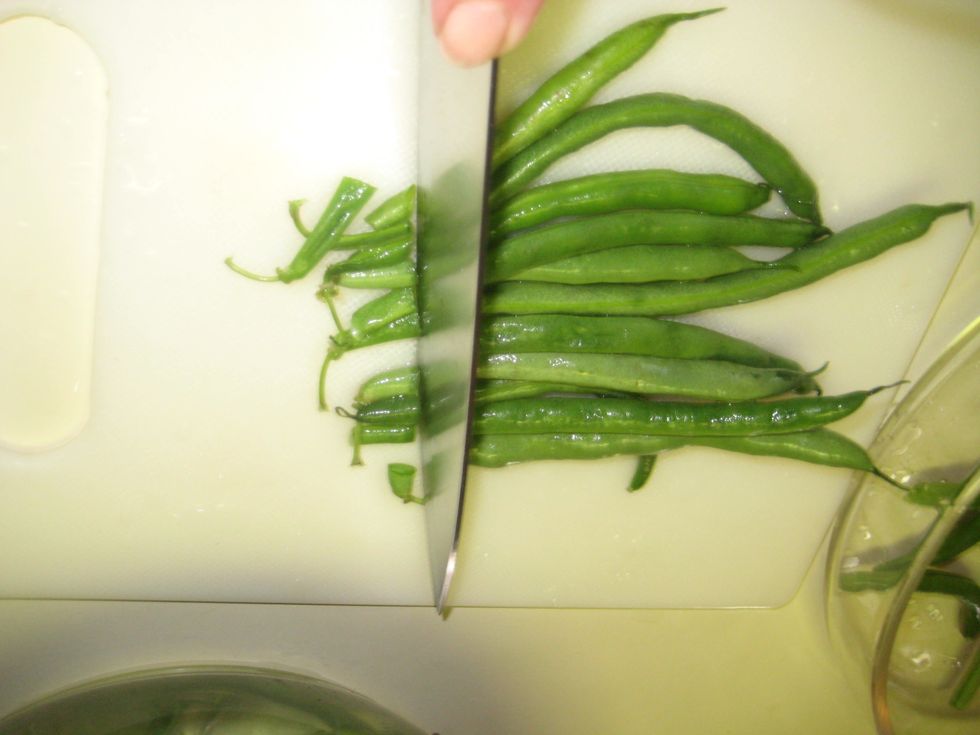 To Wash the beans (I like to use a solution of water and a splash of white vinegar for rinsing) Rinse, strain and drain using the colander. Then slice off the stem ends.