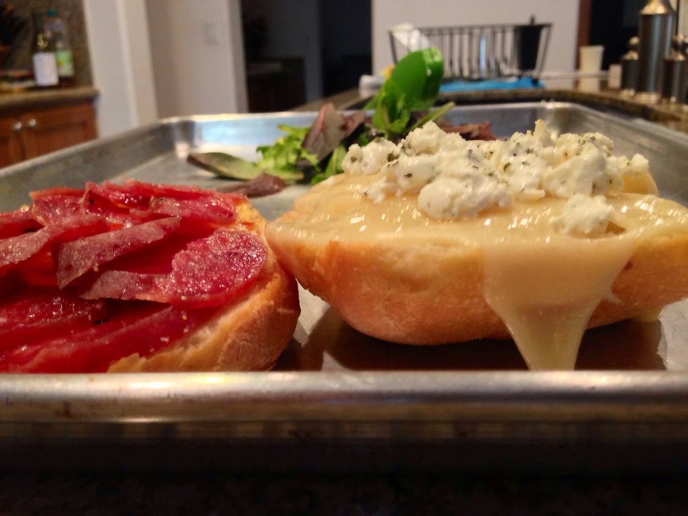 Toast both slices in a toaster oven until cheese is melted and the salami is warm.
