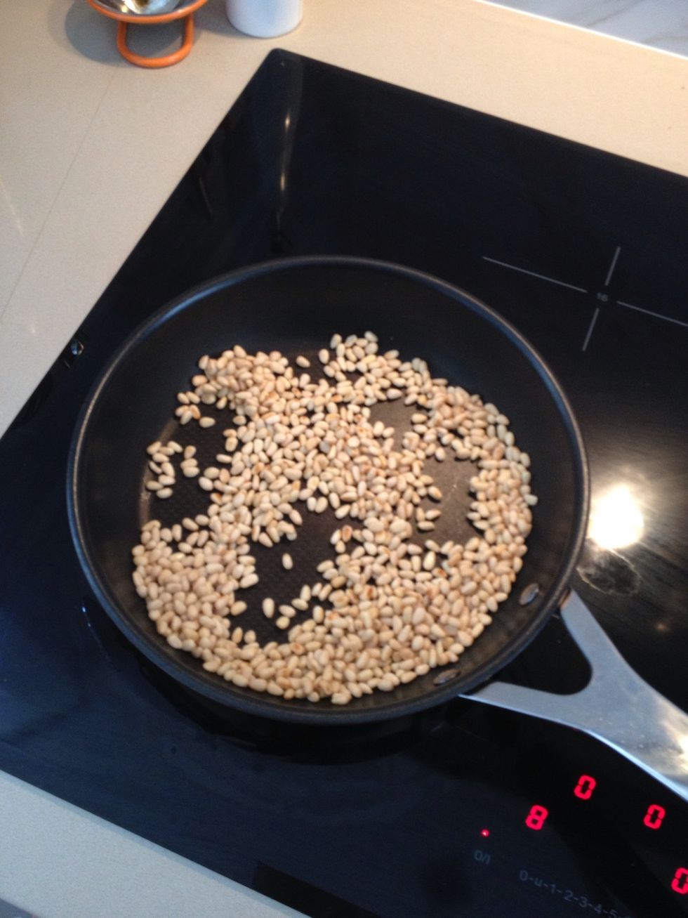 Toast pine nuts over a low heat until lightly brown