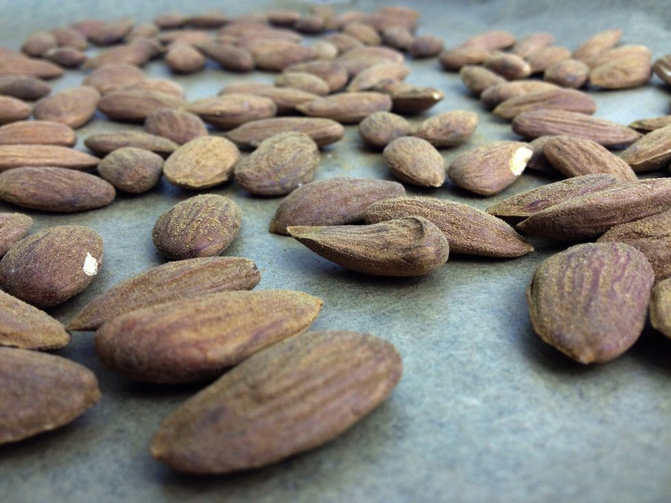 Toast the almonds in the oven for about 10 minutes and leave to cool. Keep an eye on that upturned almond. It's a rebel with an escape plan.