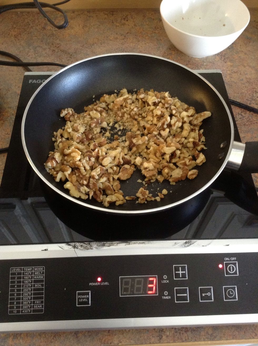 Toast walnuts in skillet for 5 minutes