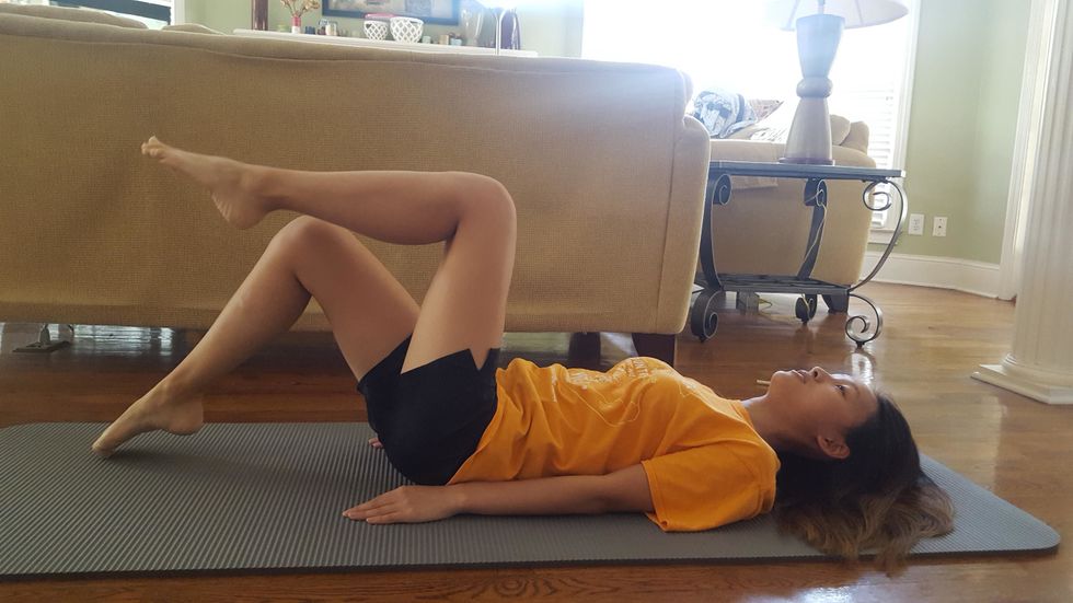 Toe taps (continued). Lighting tap one toe onto the ground. Remember to keep your back flat on the ground. This is what will isolate this exercise to work on your core strength.