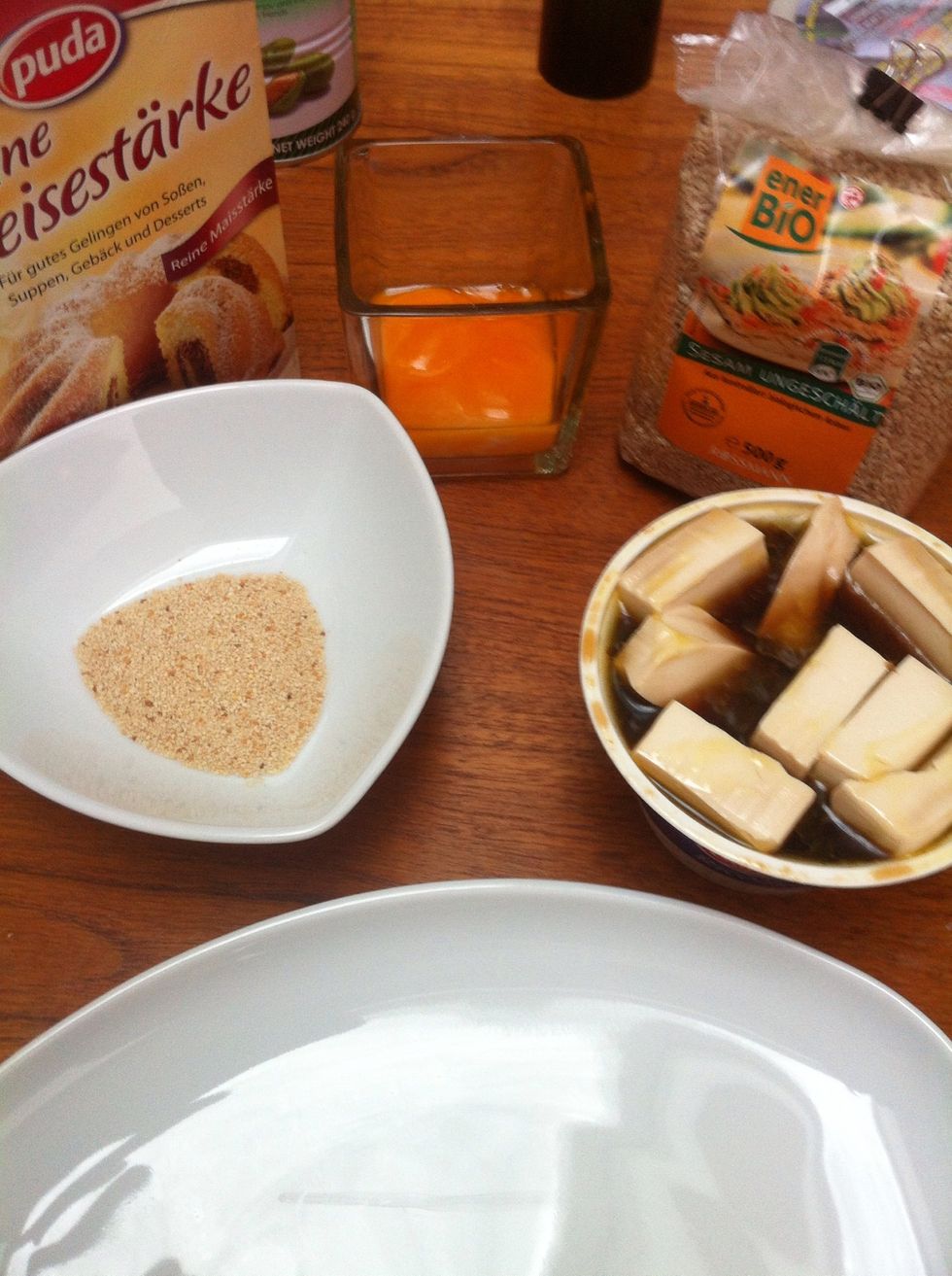 Tofu is boring. To make it more interesting we are going to crisp it up. Just whisk an egg and add a tsp of the tofu soaking liquid for seasoning. Prepare sesame seeds, bread crumbs and corn starch.