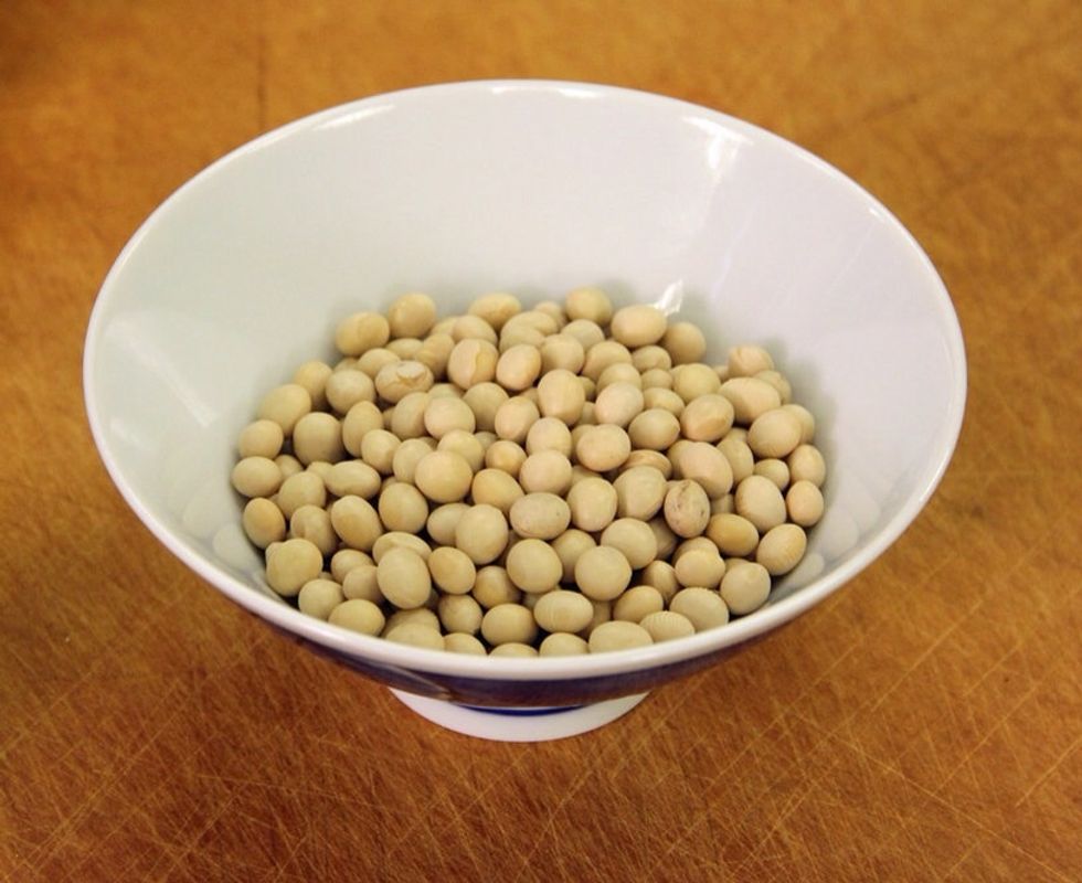 Tofu is created from dried soybeans that are soaked, pureed and cooked. A thickener is added and the extra liquid is pressed off until the desired firmness is reached.