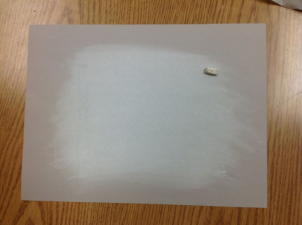 Tone bogus paper with side strokes of white chalk pastel. Blend into paper with paper towel to create even light value.