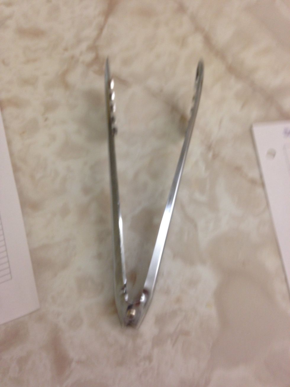 Tongs are used to pick up things. I can use tongs to serve salad or things like hotdogs.