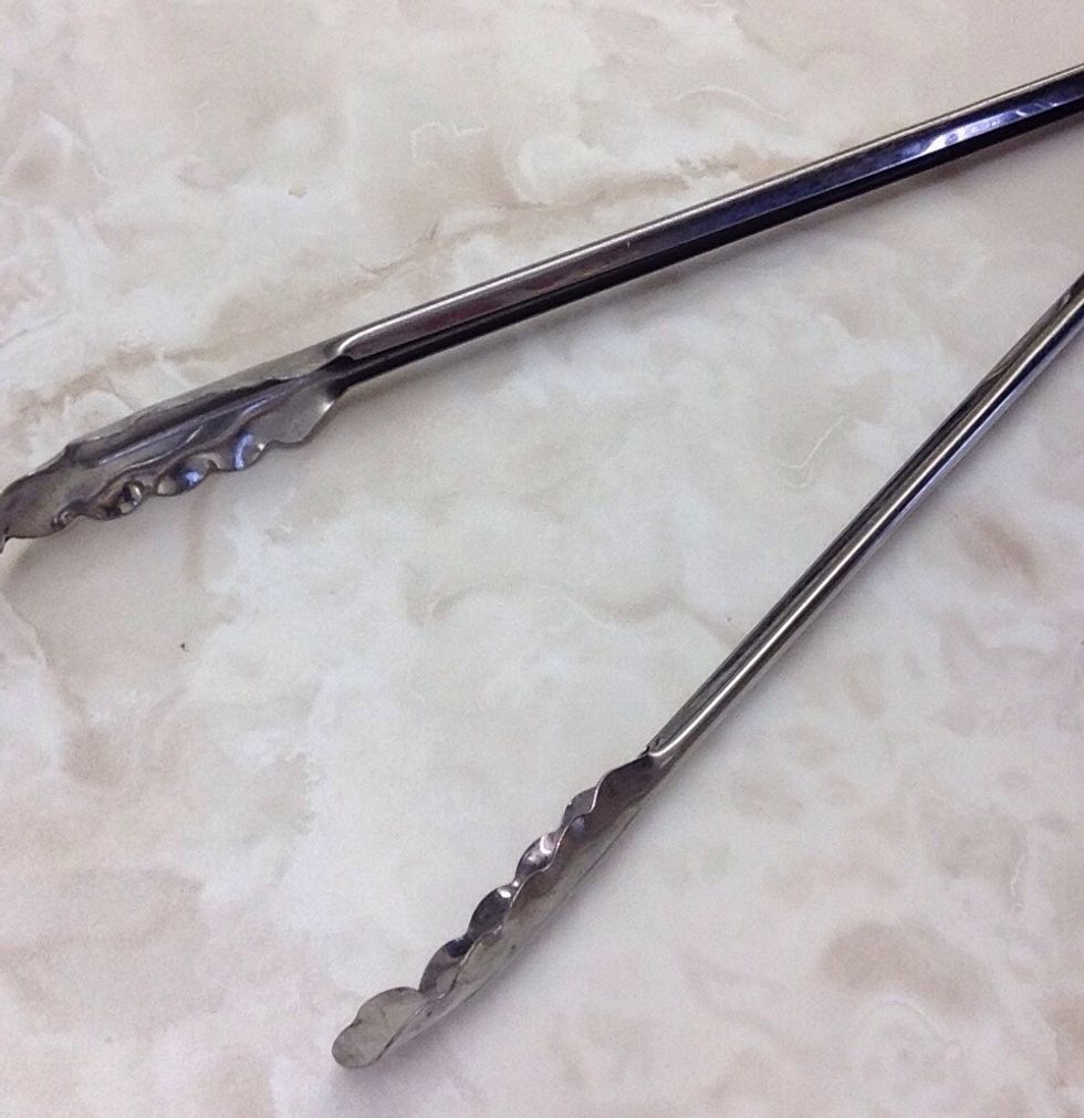 Tongs. Used for grabbing/gripping ingredients. I can use tongs when grabbing something from a pot.