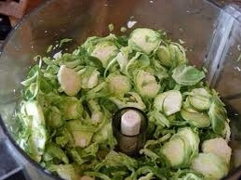 Tools: food processor, bowl Task: using food processor slice the Brussels sprouts into thin slices. Then place sliced Brussels sprouts in bowl with onions.