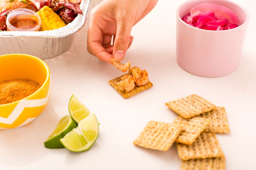 Top a TRISCUIT Cracker with some crawfish meat.