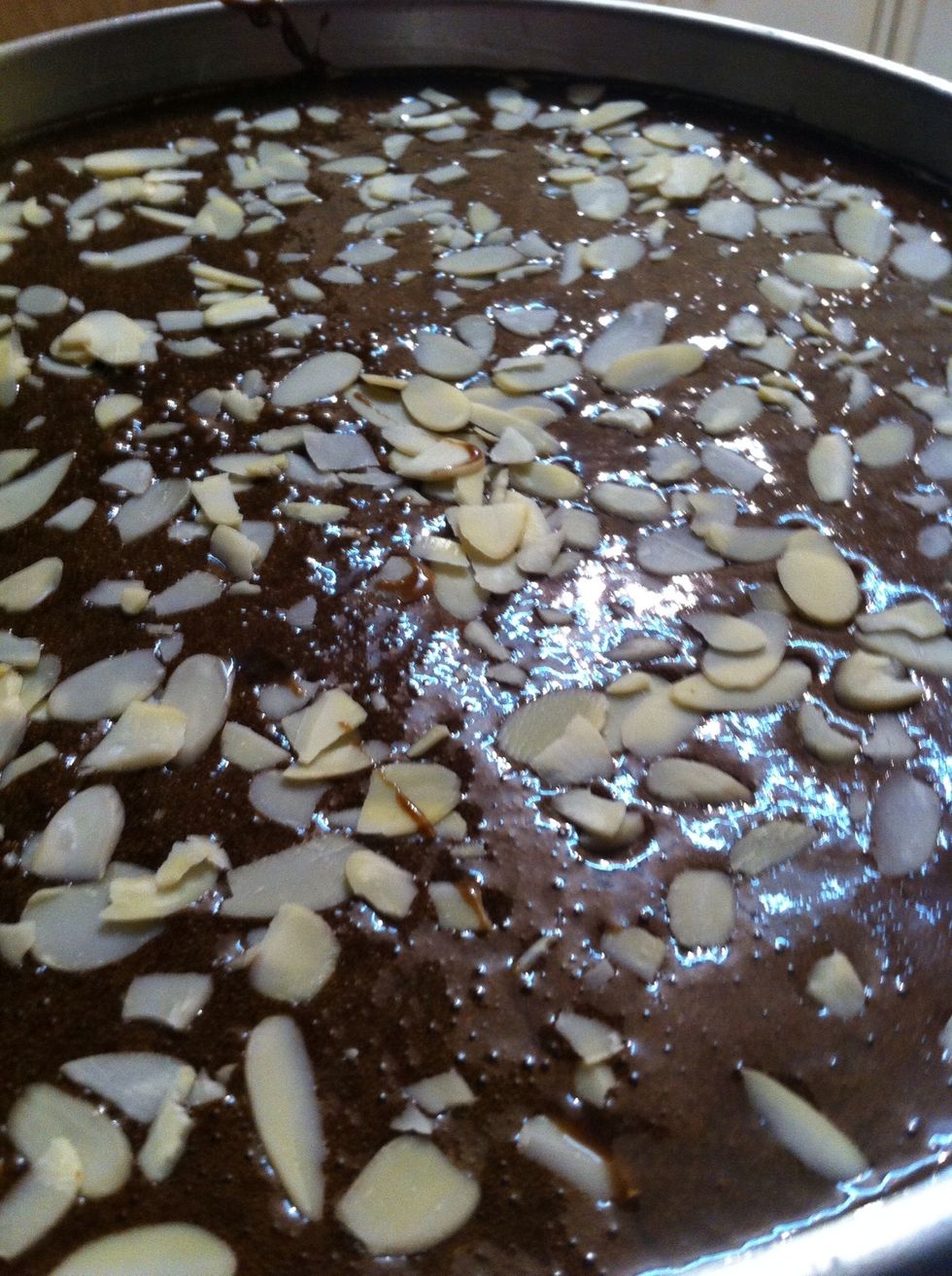 Top it off with almond flakes. This is optional so suit yourselves. Pop the pan in the oven for 40-50 min. Check with a fork before taking it out of the oven if it's cooked properly. 50min does it