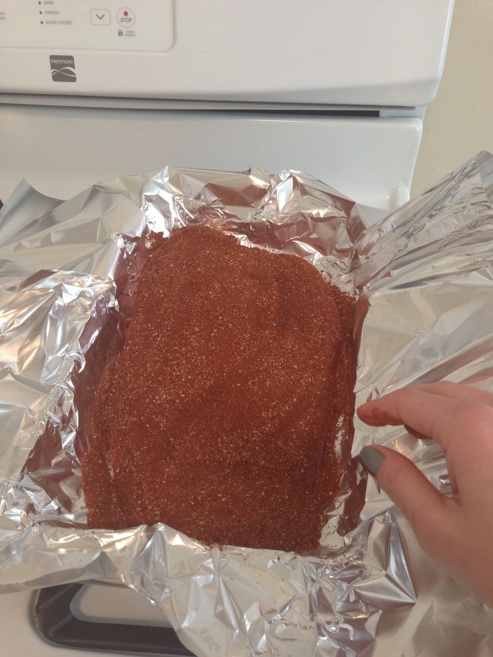 Top layer of the brisket covered in dry rub.
