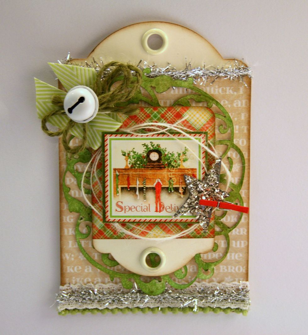 Top ribbon with twine bow tied with painted jingle bell.