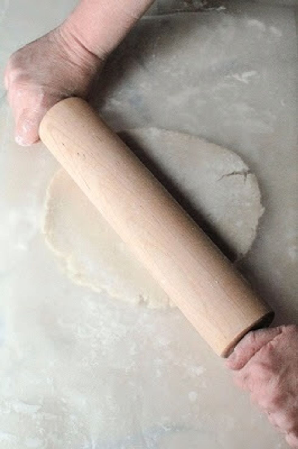 Top the dough with a second sheet of waxed paper. Roll the dough out between the two sheets of waxed paper. It keeps the dough from tearing.