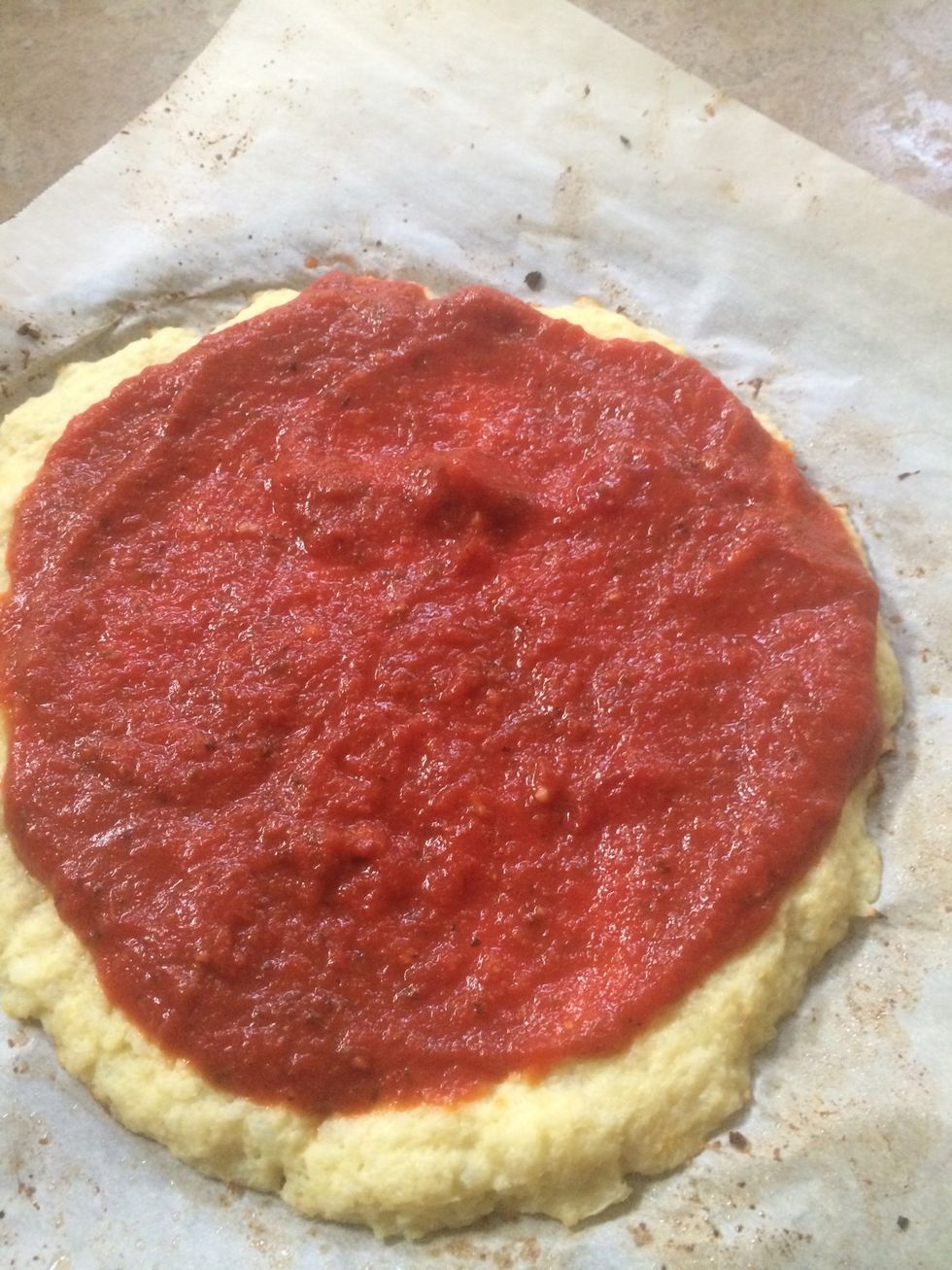 Top the pizza with the sauce.