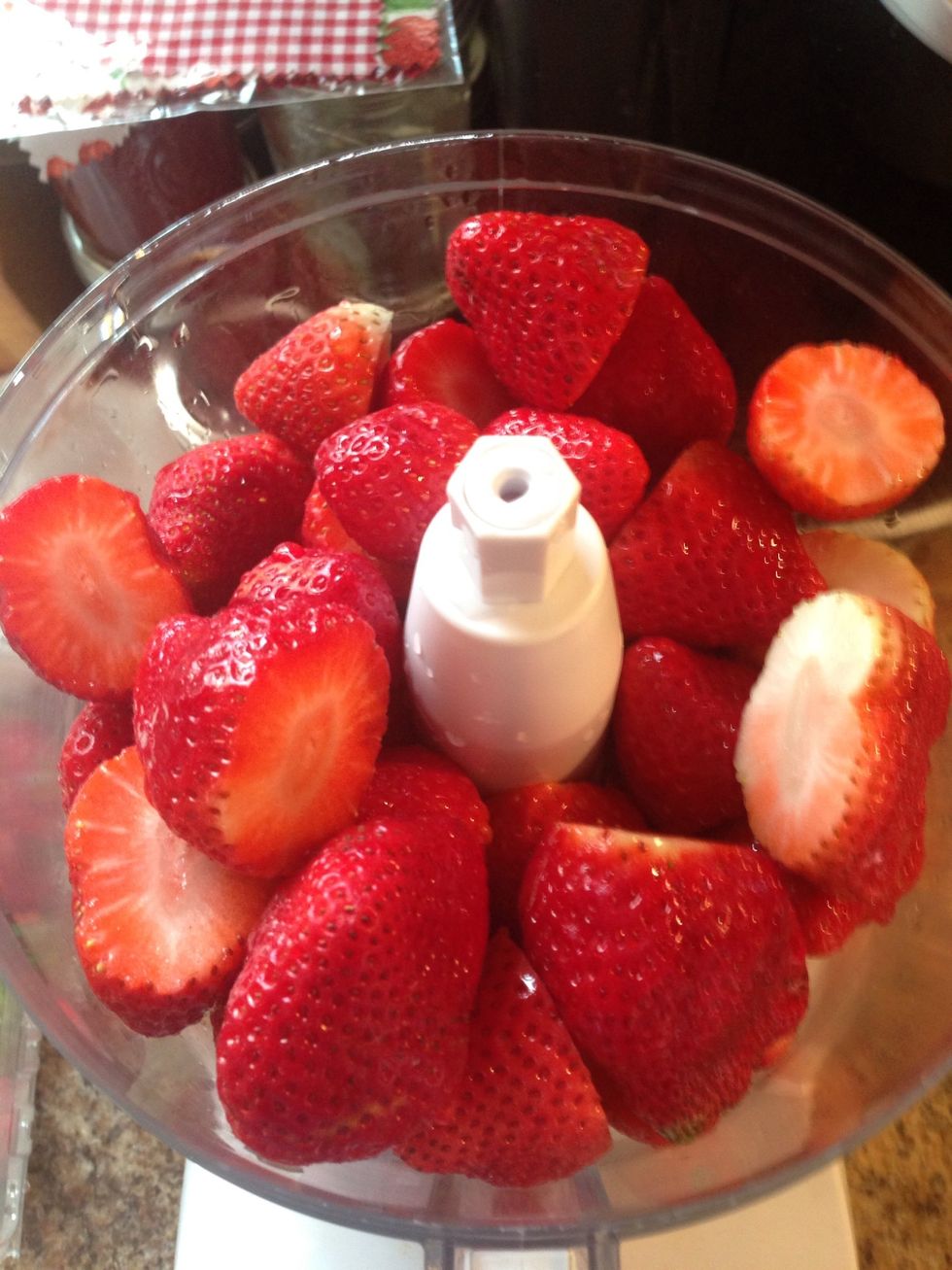 Top the strawberries and wash them in cold water. I use a food processor for a smoother consistency. If you want chunky don't process as much, or use a potato masher and crush by hand.