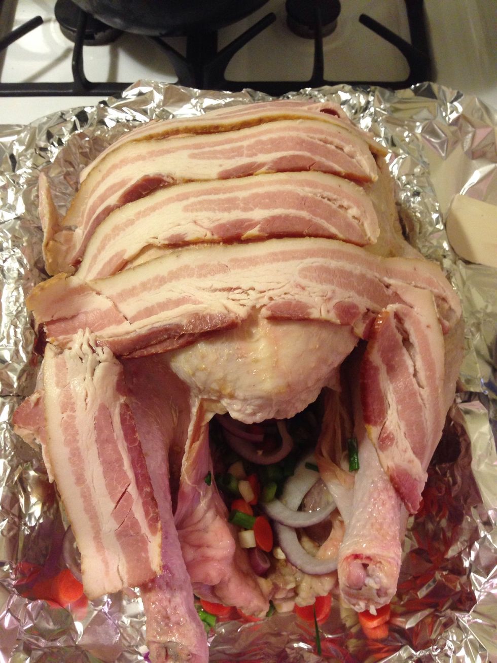 Top the turkey with bacon. This will help keep the breast moist and not dried out.