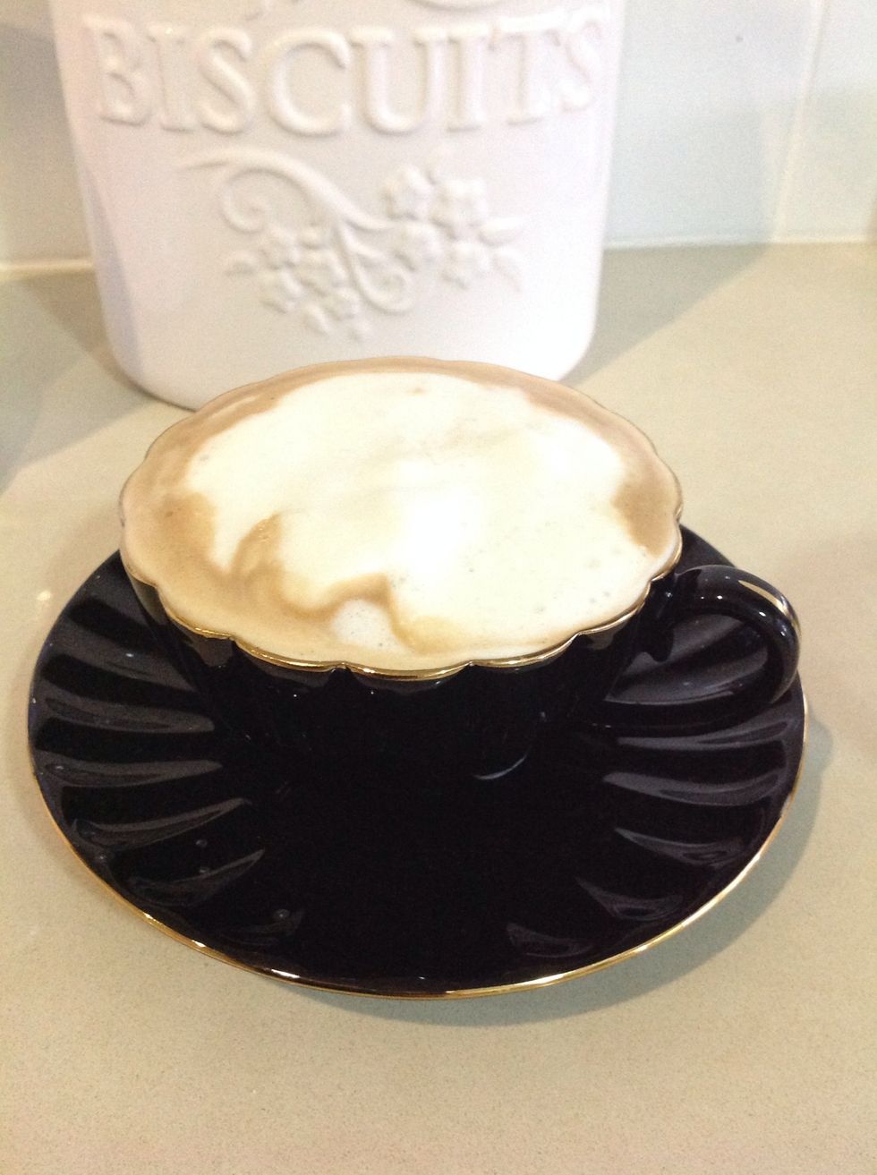 Top up your coffee with some more milk until the froth reaches the rim of the cup.