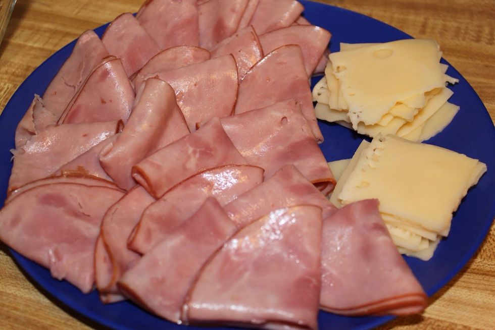 Top with a layer of ham, followed by a layer of cheese, finishing with the tops of the buns.