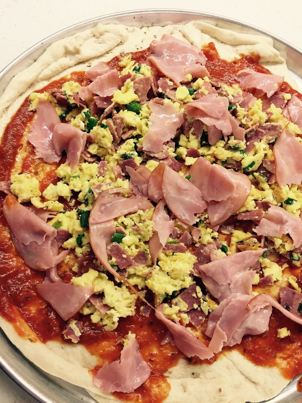 Top with bacon, scrambled eggs, ham.