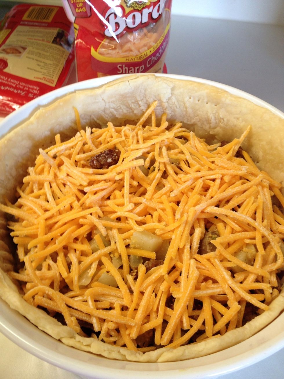 Top with cheese. And repeat for a second layer of sausage and potatoes; then cheese.