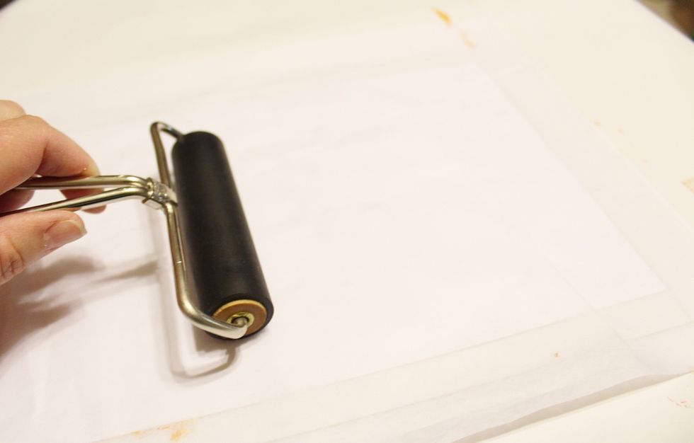 top with coversheet and then use brayer to press ink to paper...
