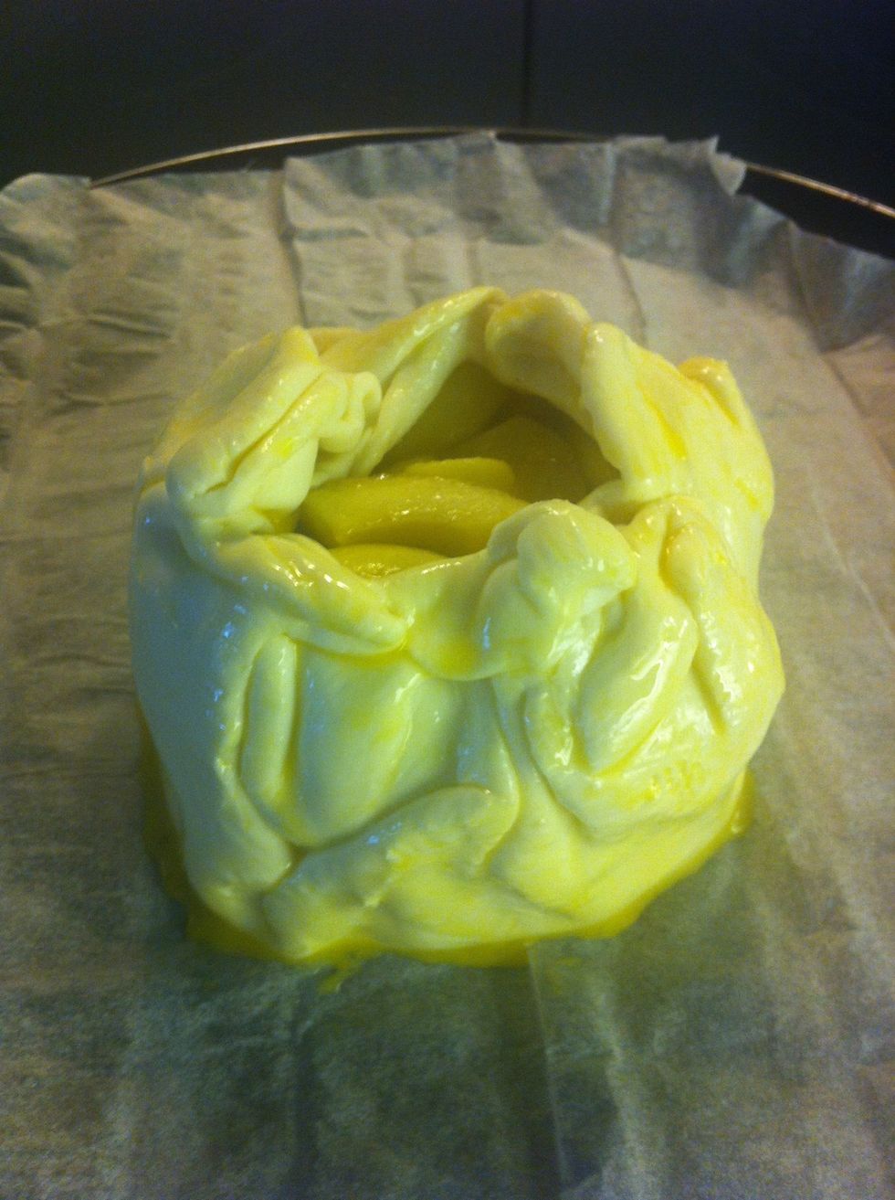 Top with disc two. Layer with the remaing compote. Bring the puff pastry up around the edges of the brie-apple-layers. Fold and pinch the edges so that a small portion of the top surface is exposed.