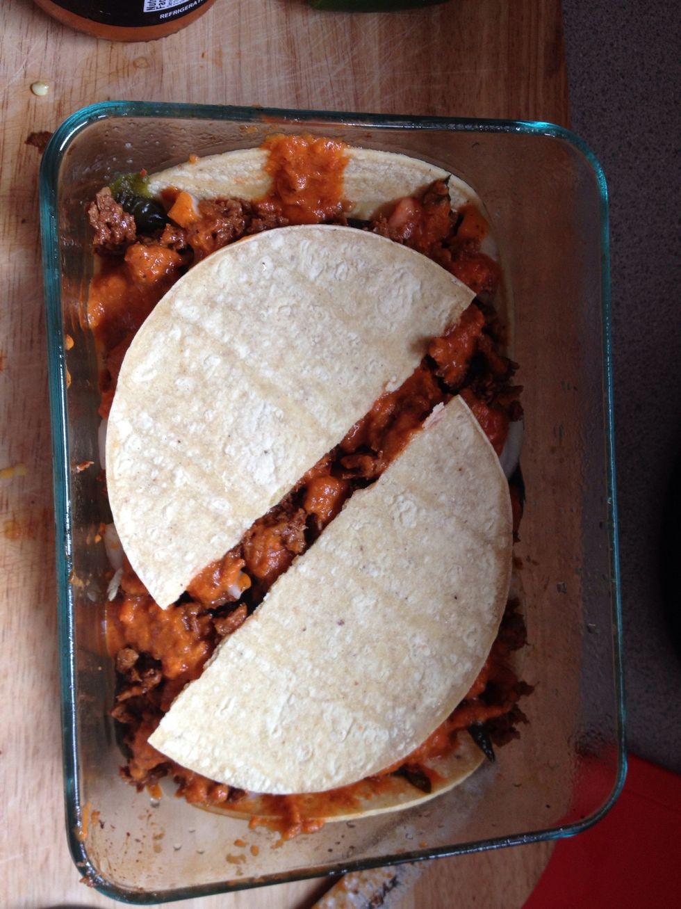 Top with more sauce and top off with the rest of your tortilla.