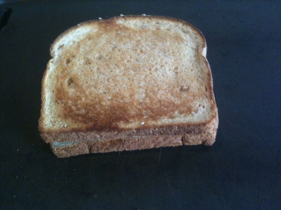 Top with remaining slice of bread. Grill on both sides until cheese is softened and bread is golden brown.