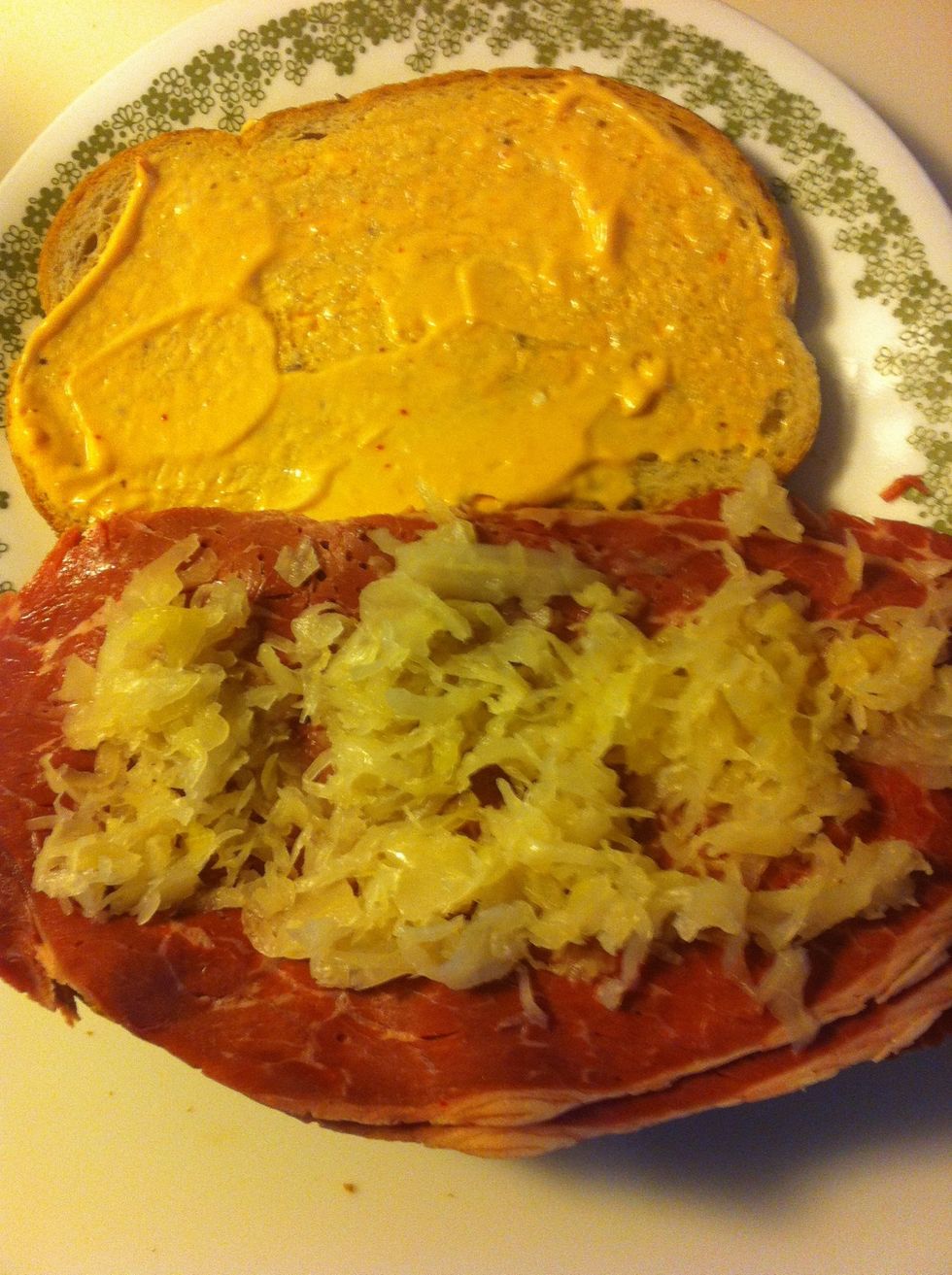 Top with sauerkraut. Spread it equally.