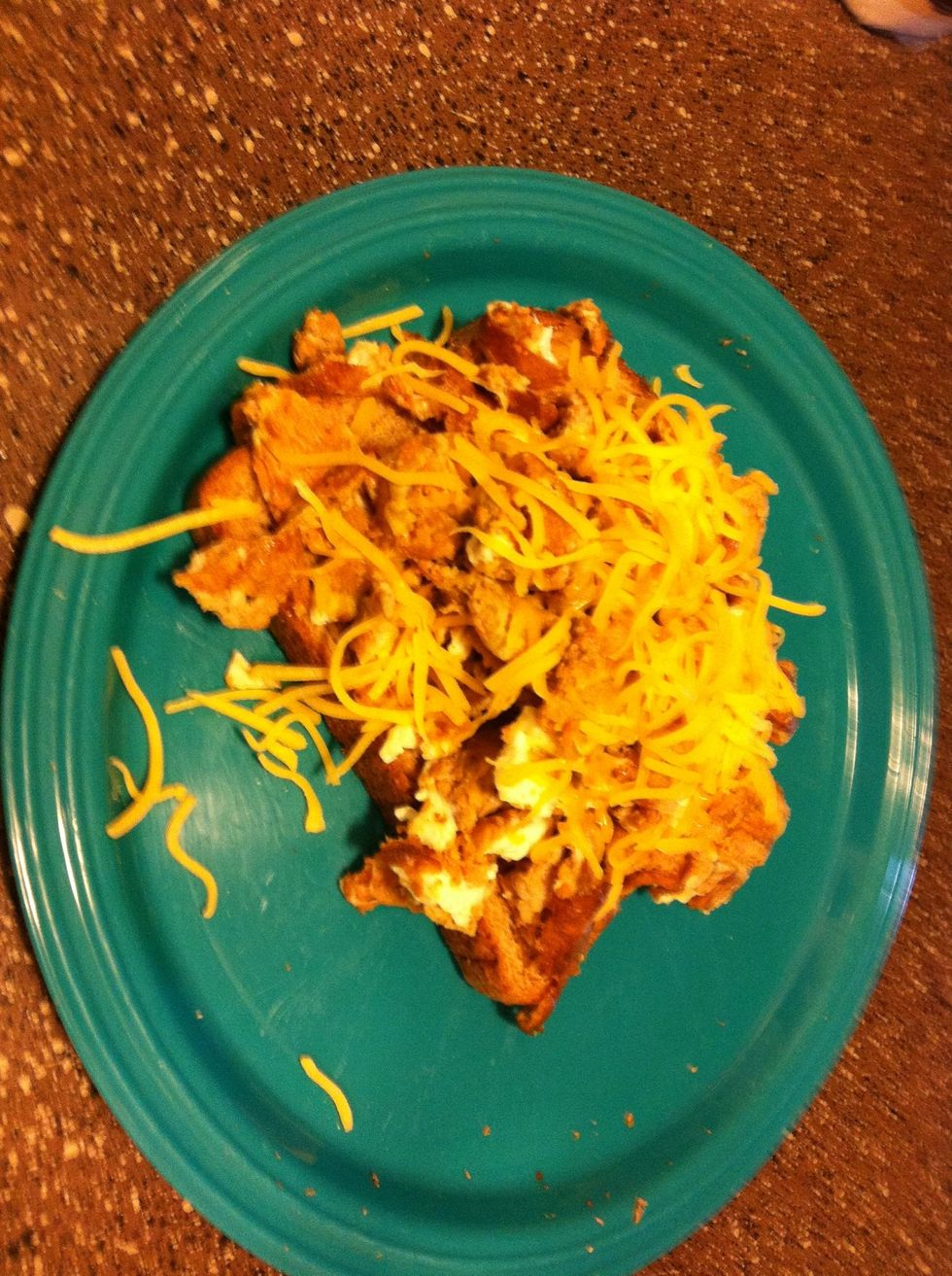 Top your toast with the cooked egg combination and top with 2 tsp of shredded cheddar. Chow down!